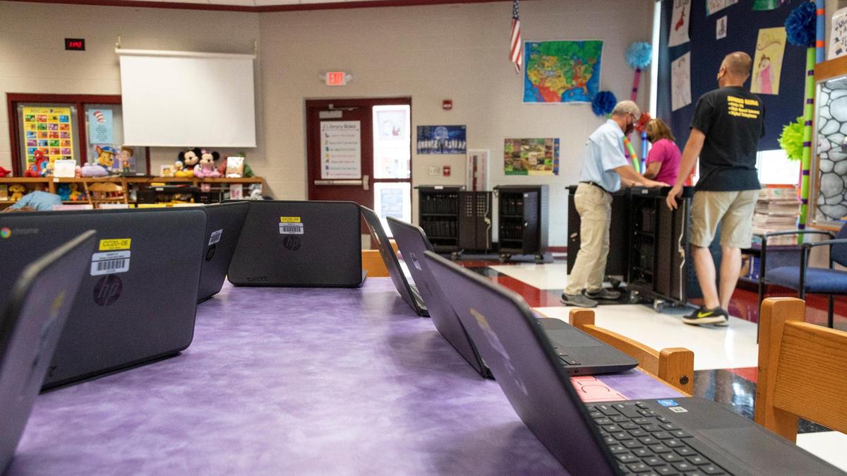 Computer technicians unload Chrome Books that will be given to students to take home at McCreary Elementary School in Stearns, Ky., Thursday, August 13, 2020. The county is planning that high school students will receive a Chromebook to take home for their classes and elementary school students will take home Kindles. The county was able to purchase more chromebooks to help transition to online classes this fall.