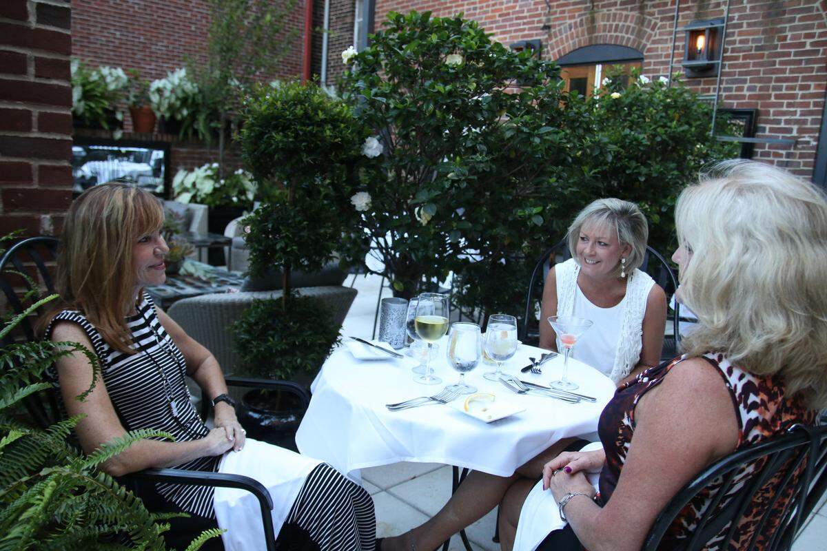 From left, Ann Creel, Laura Taylor and Tina Thorn had appetizers and wines recently on the outdoor patio at Dudley’s on Short in downtown Lexington.