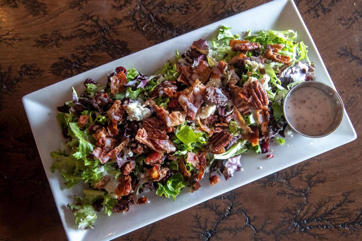 The poppy blue salad, a spring mix with dried cranberries, candied pecans, blue cheese crumbles and bacon tossed in a poppy cranberry dressing, at Luna’s Coffee, Wine & Butterfly Cafe.