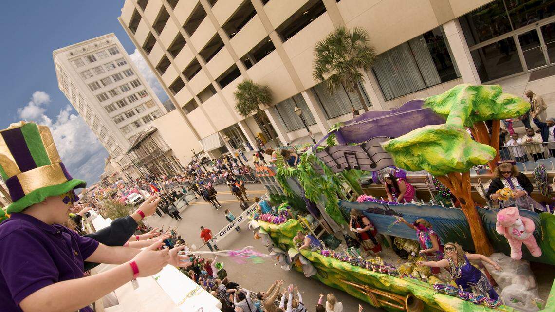 Mardi Gras revelers watched a parade from the balcony of the Battle House Hotel. Mardi Gras originated in Mobile. 