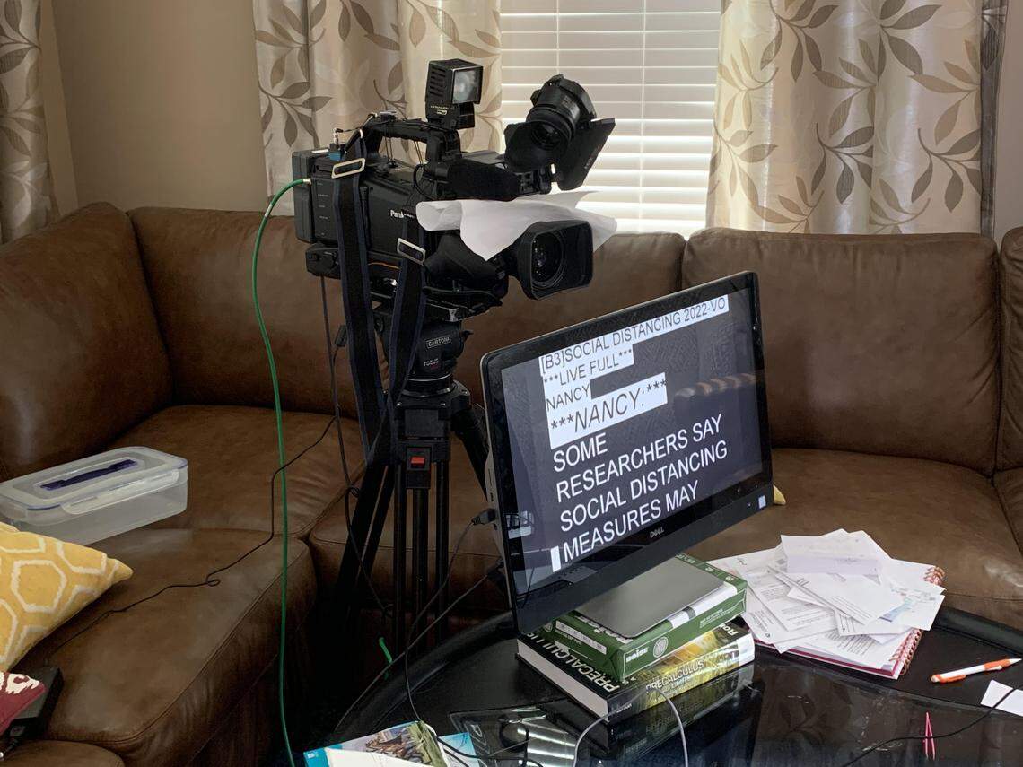 The camera and prompter set up in Nancy Cox’s living room are there for the duration.