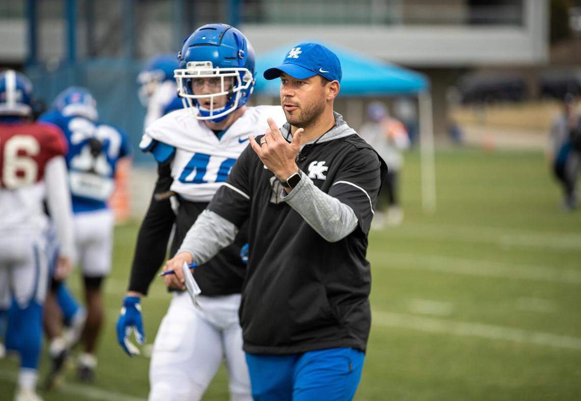 Former Kentucky Wildcats assistant coach and linebacker Jon Sumrall, right, now the head coach at Tulane, is being mentioned with all the top head coaching vacancies on what is an already spinning coaching carousel.