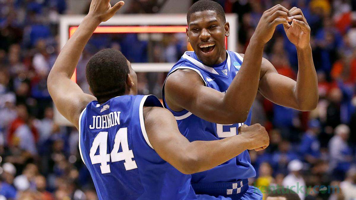 Kentucky Wildcats center Dakari Johnson (44) and Kentucky Wildcats forward Alex Poythress (22) cel;berated as the University of Kentucky played the University of Louisville in Lucas Oil Stadium in Indianapolis, In., Friday, March 28, 2014. This is second half NCAA Midwest Regional semifinal action. UK won 74-69. Photo by Charles Bertram | Staff