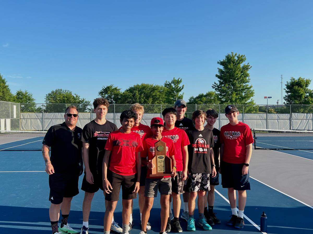 Eighth grader Atharva Dang (holding the trophy) helped lift Paul Laurence Dunbar to victory against Lexington Catholic for the first 11th Region team championship.