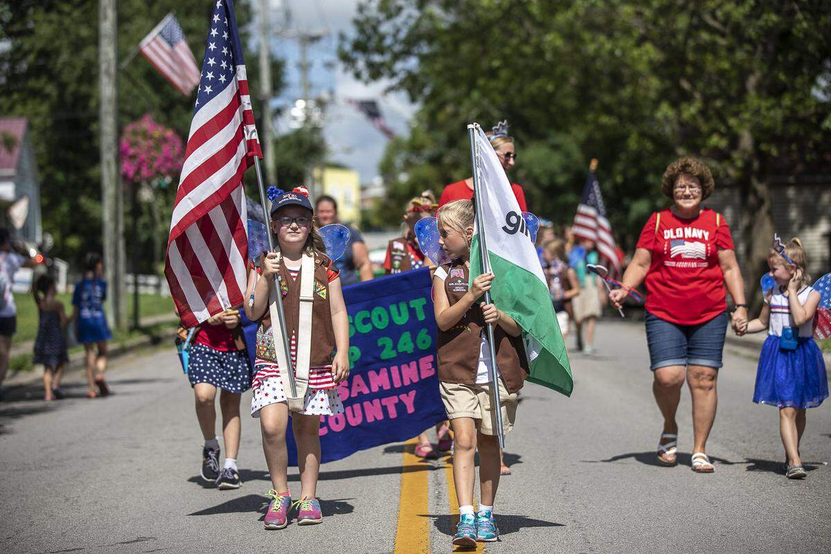 Members of Jessamine County’s Girl Scout Troop 246 walk in the Wilmore Festival of the Fourth parade.