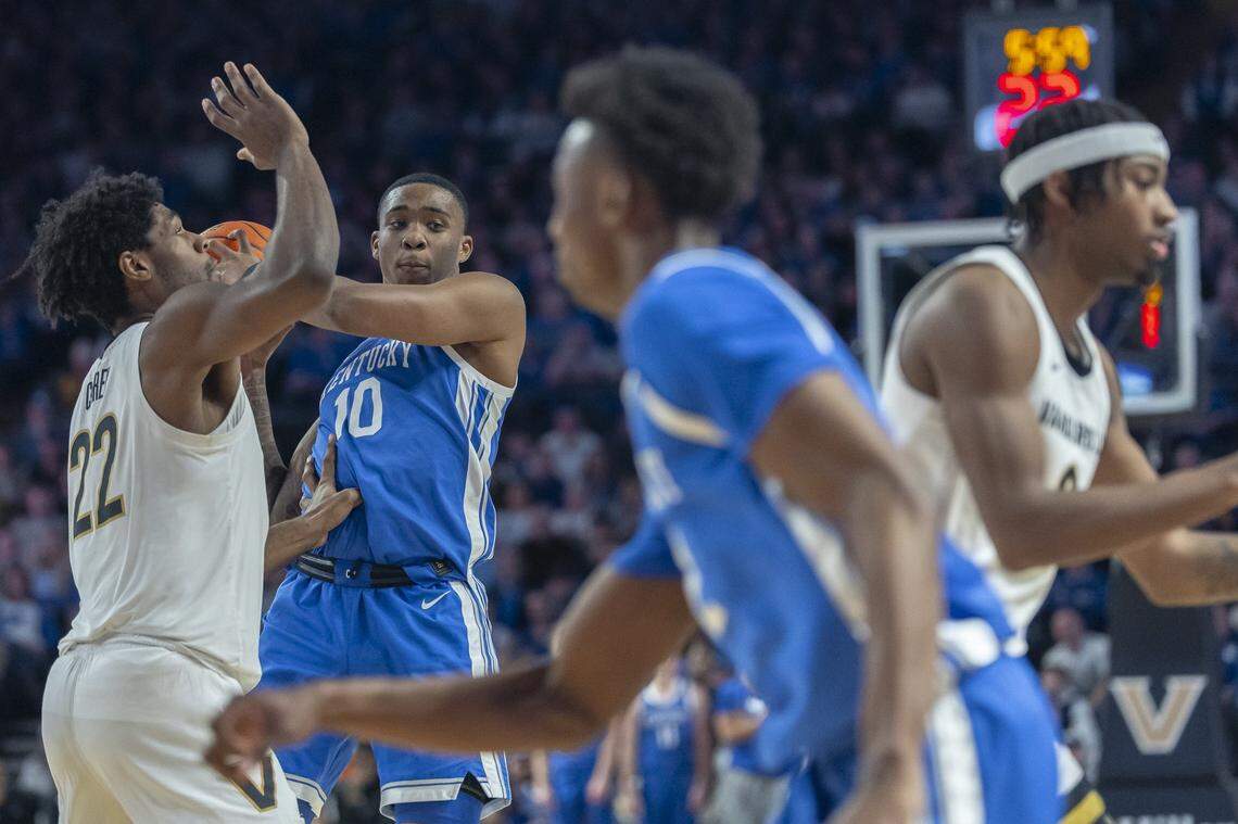 Kentucky’s Brandon Garrison (10) looks to pass while guarded by Vanderbilt’s Jaylen Carey (22) during Saturday’s game at Memorial Gymnasium in Nashville.