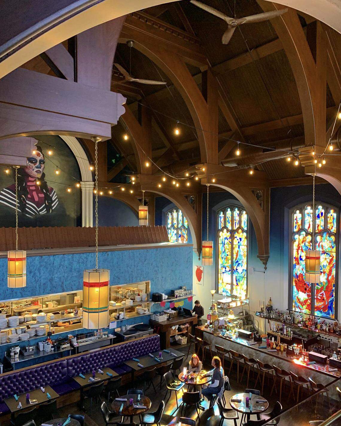Mexican BBQ restaurant Noche is located in what was once the Calvary Lutheran Church and features the large stained glass windows and pipe organ in the balcony from its church days.