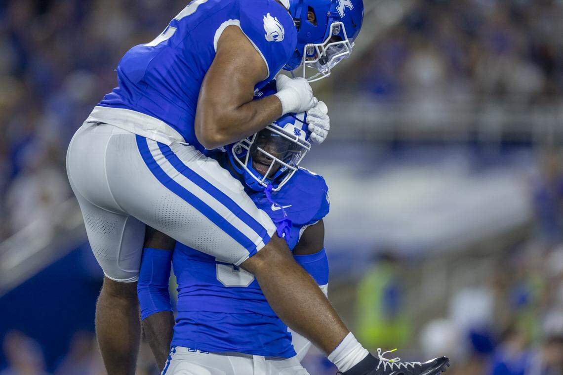 Kentucky linebacker Jamon Dumas-Johnson, left, and defensive back Alex Afari Jr. celebrate during Saturday’s win against Southern Miss at Kroger Field.