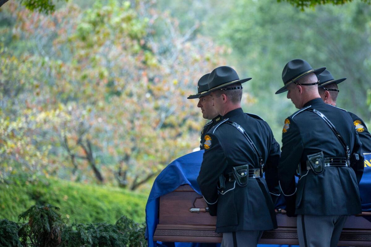 The Kentucky State Police Honor Guard carries the casket of former Kentucky Gov. Brereton Jones into the Kentucky state Capitol in Frankfort, Ky., on Monday, Sept. 25, 2023.