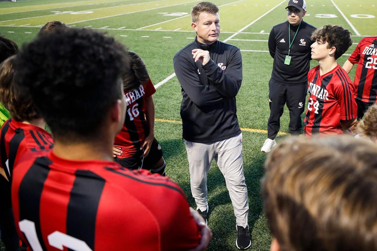 Paul Laurence Dunbar head coach James Wray speaks with his team during Wednesday night’s state semifinal win over Elizabethtown. The Bulldogs are seeking the school’s fifth boys’ state soccer title.