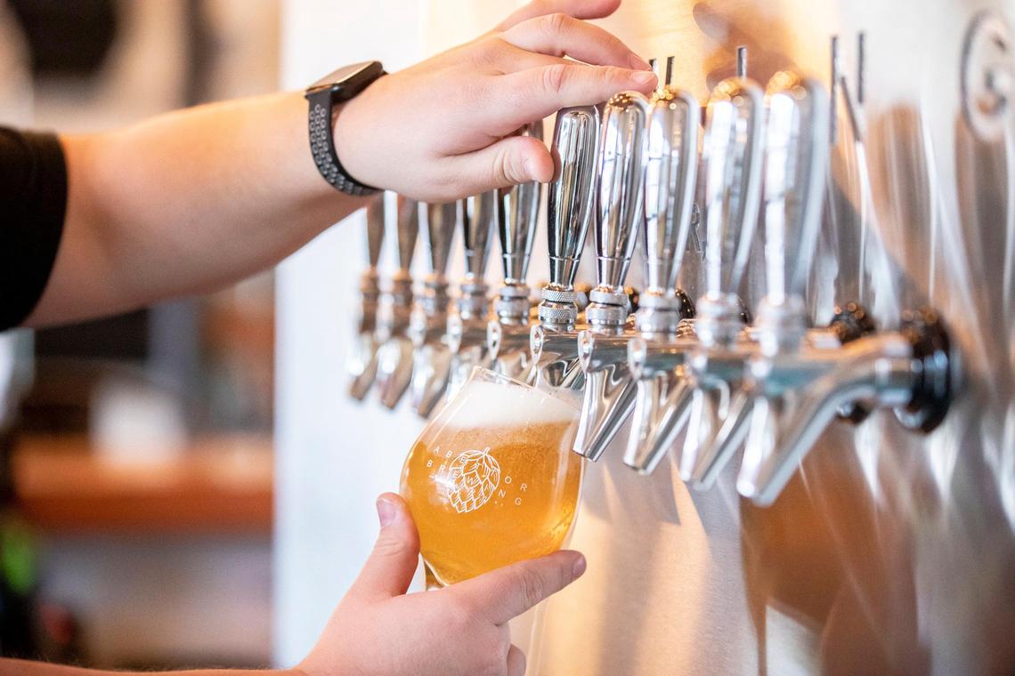 John Howard, tap room manager, pours an VIII the Pils at Abettor Brewing.. Abettor also features a lineup of signature cocktails.