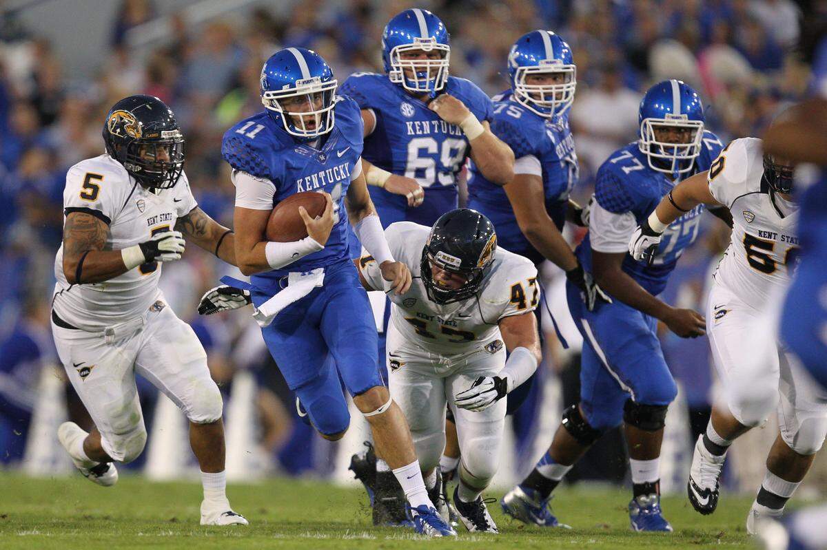 Kentucky Wildcats quarterback Maxwell Smith scrambled out of the  pocket during UK’s 47-14 win over Kent State of the Mid-American Conference in 2012.