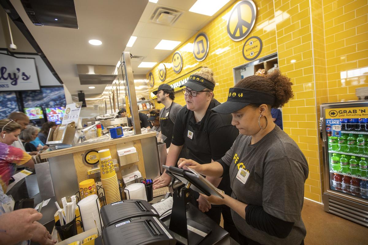 Jasmine Overstreet, right, and Elizabeth Goodlett, second from right, ring up customers’ orders at the new Which Wich in the Crossroads IGA on Leestown Road on Wednesday, April 24, 2019.
