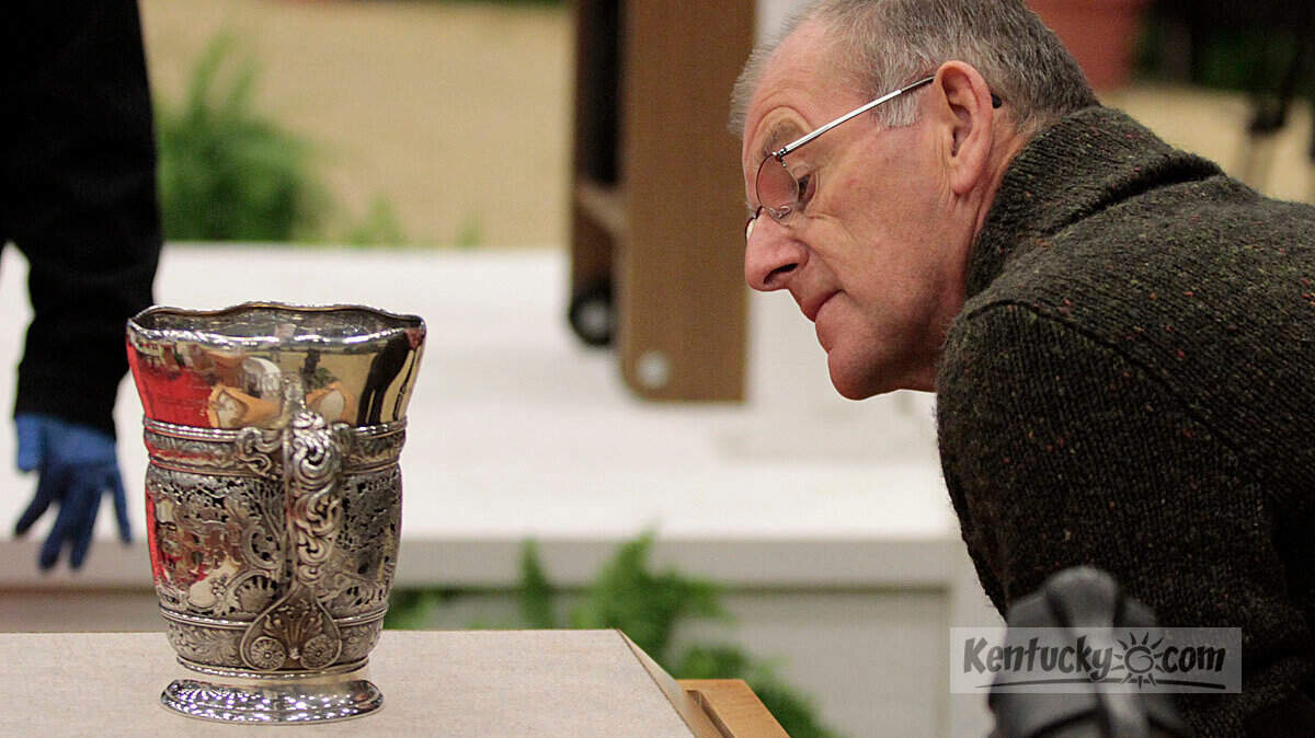 Richard Jeffery, the course designer for the National Horse Show, looked at the oldest trophy unveiled Monday, Oct. 31, 2011, at the Alltech Arena at the Kentucky Horse Park. The trophy was the first presented at the National Horse Show in 1883. Some of the horse show's prized trophy collection was put on display.