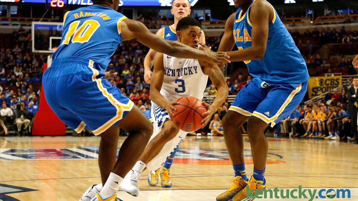 Kentucky Wildcats guard Tyler Ulis (3) drives through UCLA Bruins  guard Isaac Hamilton (10) and forward Kevon Looney (5) during the  second half at the United Center Saturday, Dec. 20, 2014 in  Chicago, Ill. Photo by Amy Wallot