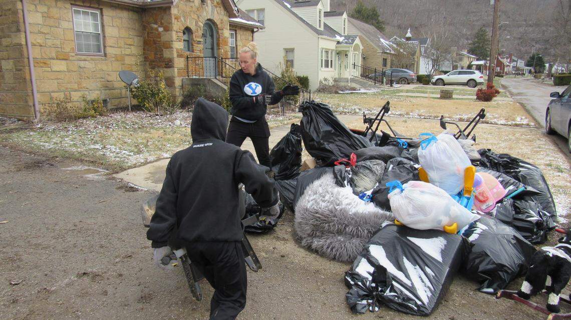 Adam Clement, left, and his mother Stephanie Clement helped carry soggy debris out of a neighbor’s house in Hazard, Ky., on Feb. 17, 2025 after flooding hit the city.