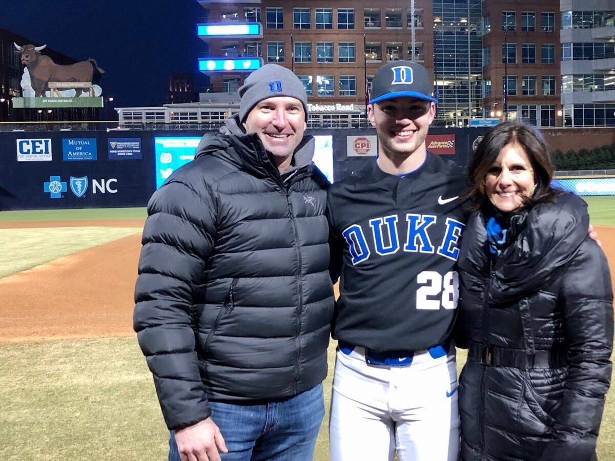 Bryce Jarvis (center) pictured with his mother and father after throwing a perfect game for Duke University in February.