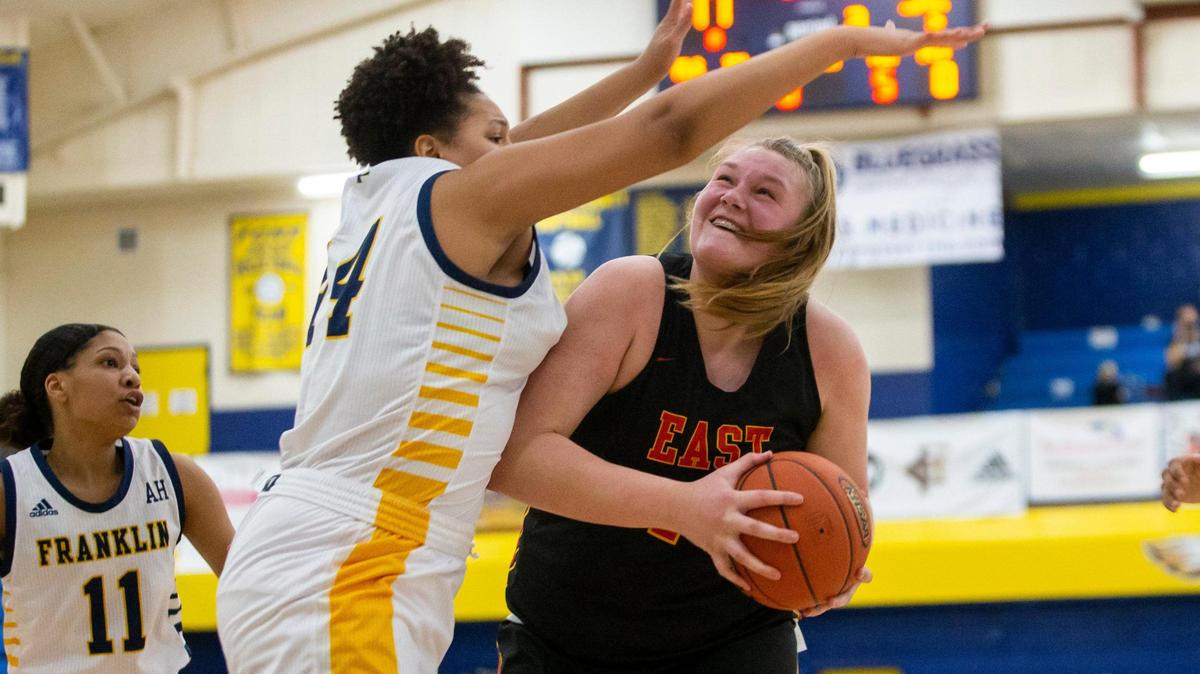 Bullitt East’s Gracie Merkle (44) looked for a shot while guarded by Franklin County’s Jhaven Meade (44) during the second half of the game at Franklin County High School in Frankfort Monday, February 22, 2021.