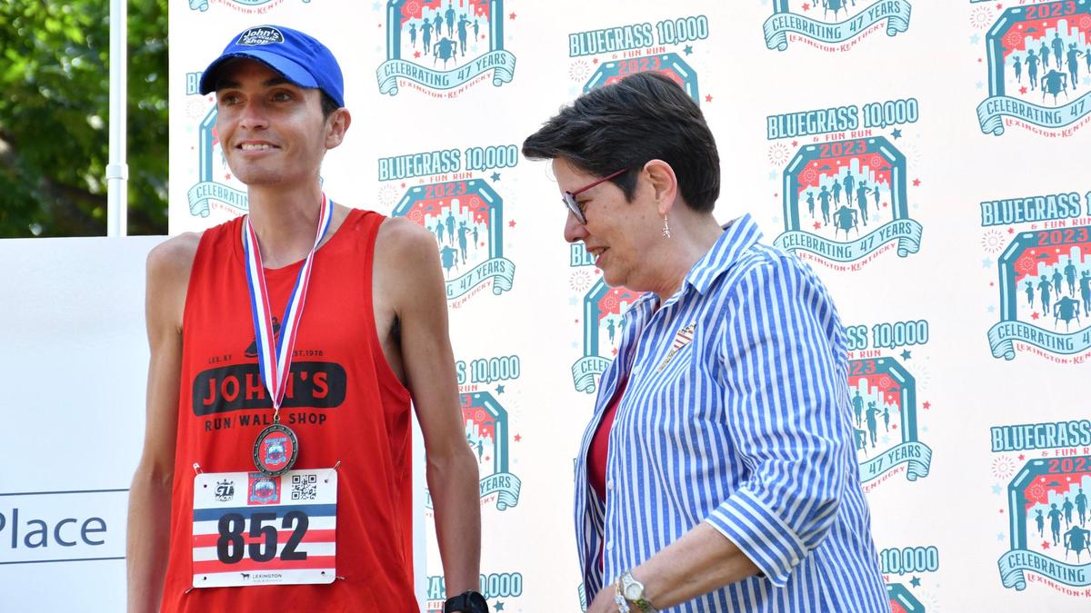 Lexington Mayor Linda Gorton awards overall winner Antonio Marchi, left, his first-place medal for the 47th annual Bluegrass 10,000.