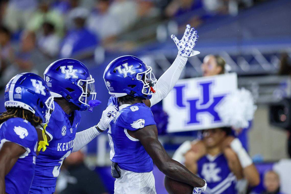 Kentucky defensive backs Maxwell Hairston, left, Alex Afari Jr. and JQ Hardaway (6) react after Hardaway made in interception against Southern Miss.