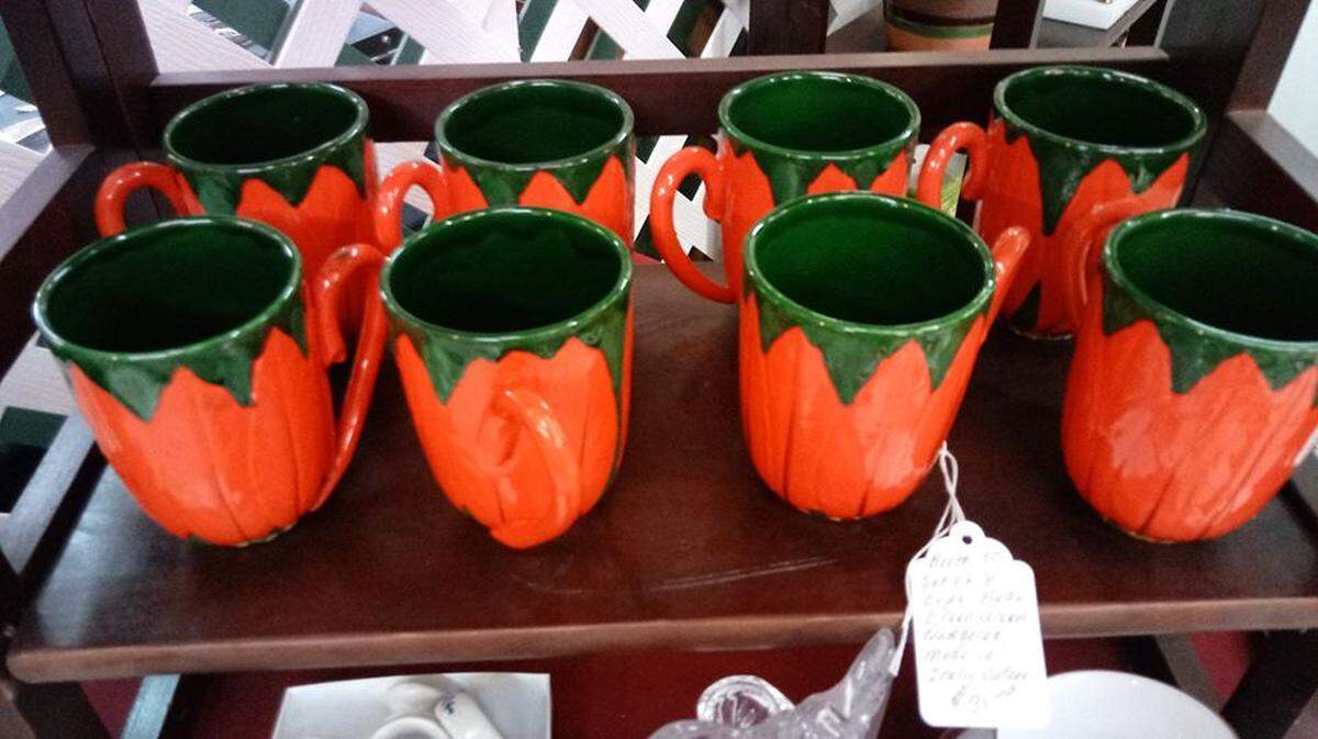 A collection of brightly colored cups at Meadowthorpe Antique Mall. The Mall is hosting its annual Christmas In July Sale.