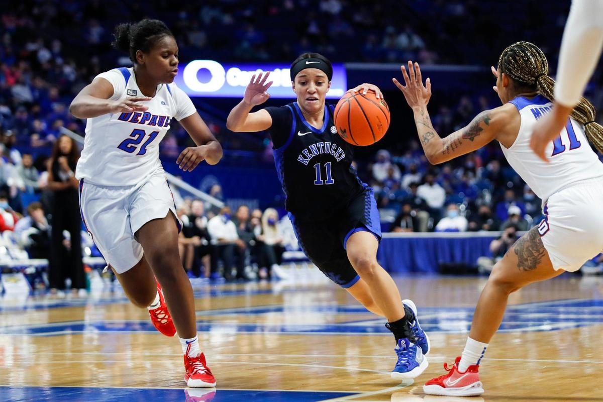 Kentucky’s Jada Walker (11) drives between DePaul’s Darrione Rogers, left, and Sonya Morris on Thursday night. Walker made her first start in place of suspended forward Dre’una Edwards and scored 18 points.