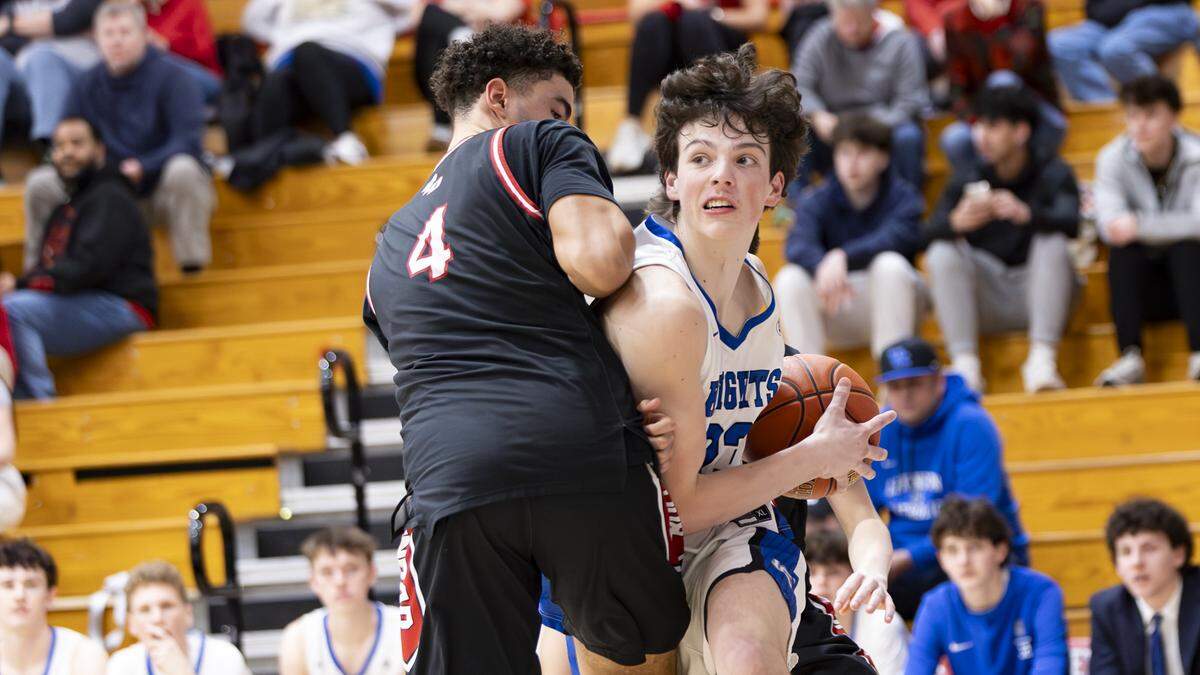 Lexington Catholic’s Everett Stuart, right, edges around Paul Laurence Dunbar’s Cage Taylor during their during the boys 43rd District Tournament semifinals at Lafayette High School on Tuesday.