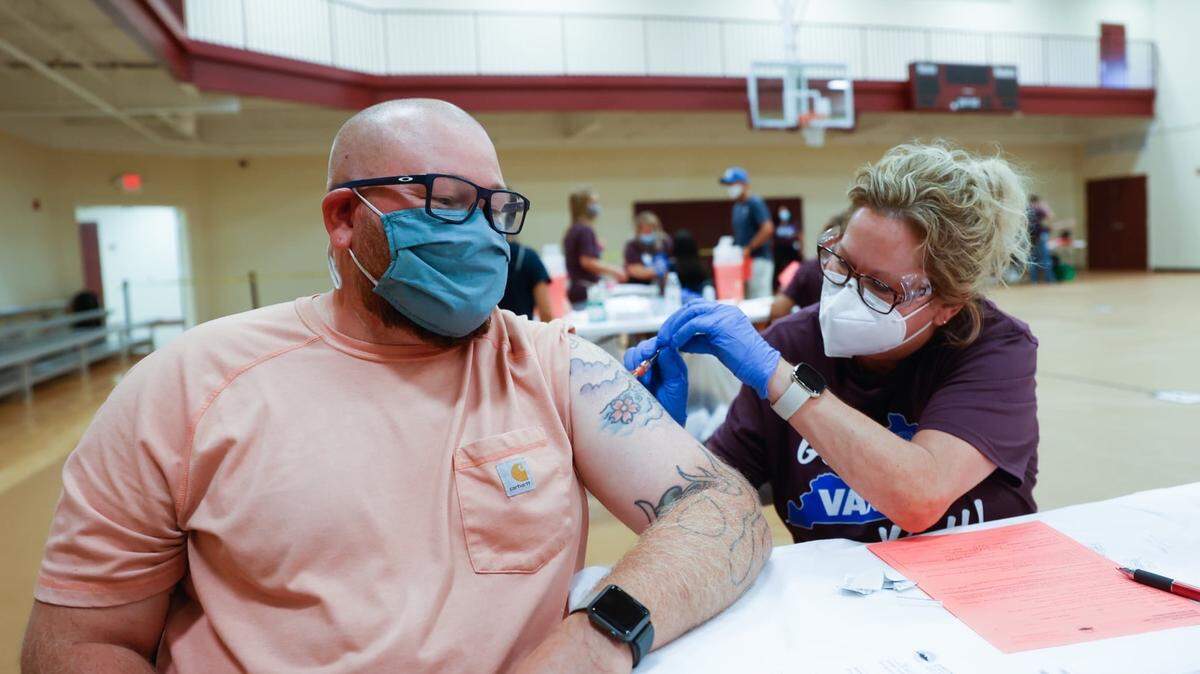 Nathan Jackson holds still for a shot, administered by an individual with the Lexington-Fayette County Health Department, during a mass vaccination clinic in 2021 at Consolidated Baptist Church. The health department is offering the vaccine again, along with these other providers. (Contributed/Mark Cornelison photo)