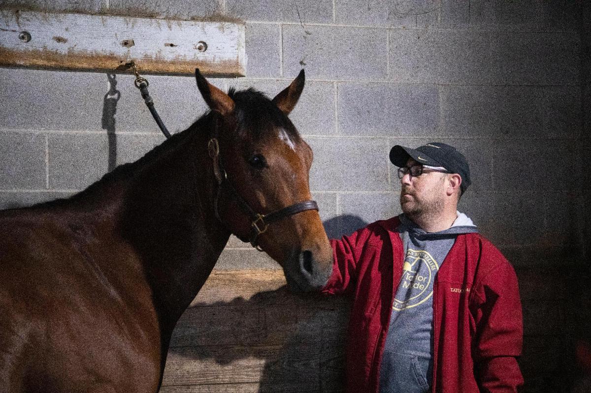 Robert Osborne cares for one of the eight horses that Ready Made Racing has stabled at Keeneland in preparation for the Spring Meet in Lexington, Ky., Thursday, March 24, 2021.