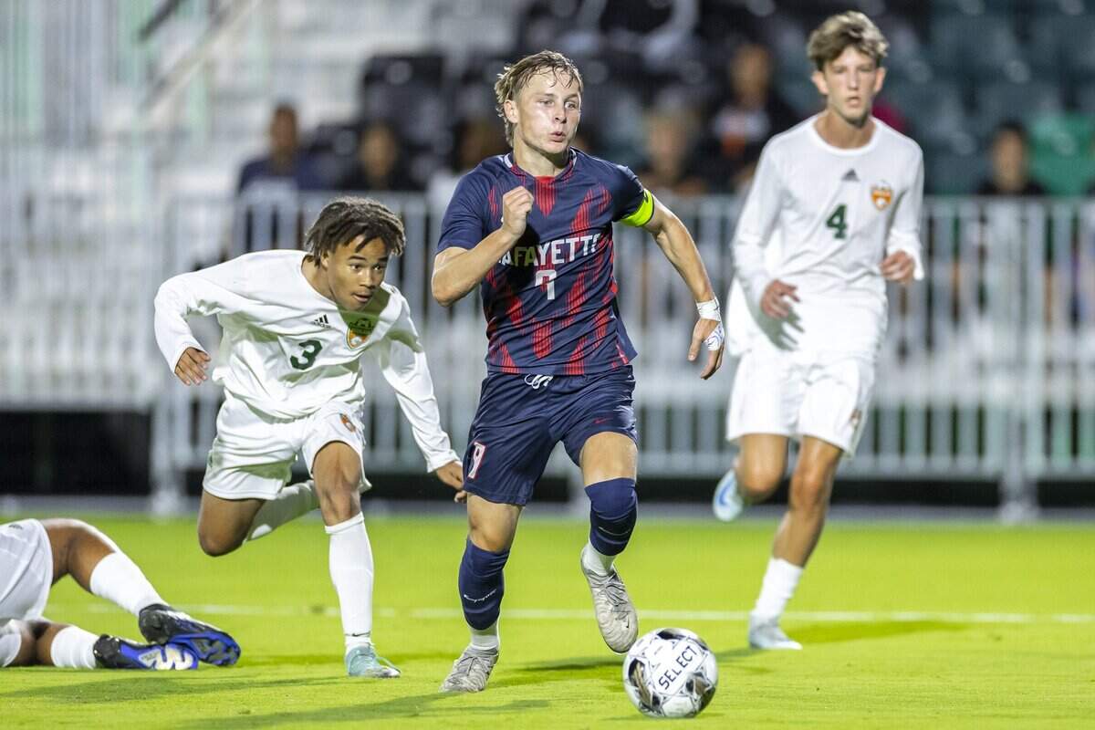 Lafayette's Max Jacobs (9) kicks the ball ahead of Frederick Douglass's Anthony Ward (3) and Frederick Douglass's Gavin Simpson (4) during a game at Lexington Sporting Club stadium in Lexington, Ky., on Thursday, Sept. 25, 2025.