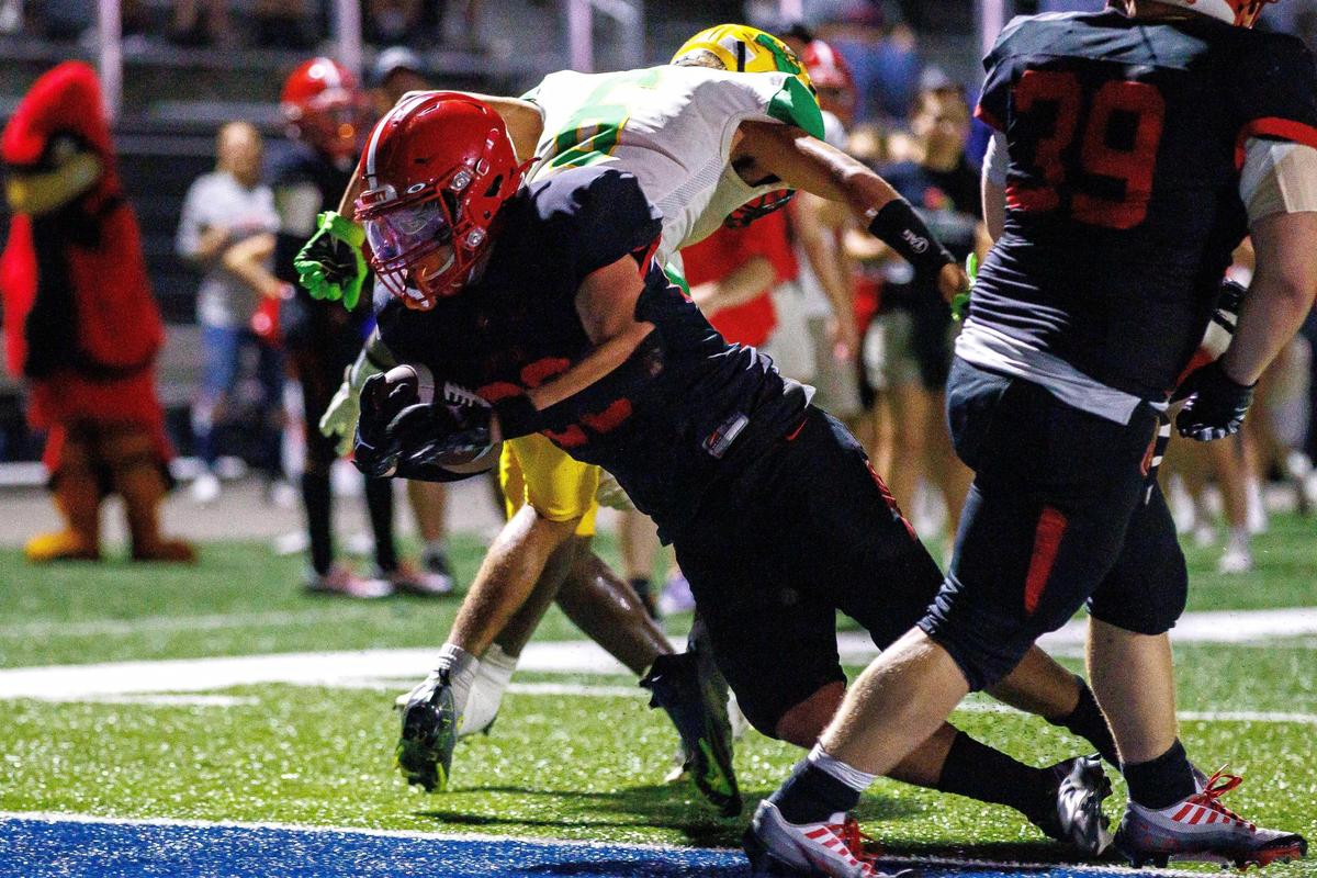 Scott County Cardinals running back Ali Hamdiyah falls into the end zone for a touchdown during the game against the Bryan Station Defenders on Friday, Sept. 9, 2022, at Great Crossing High School in Georgetown, Kentucky.