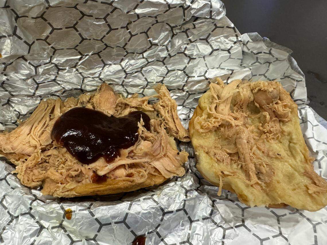 A pulled chicken sandwich with barbecue sauce is shown from a City Barbeque concession stand at Kroger Field during UK football’s season-opening game against Southern Miss.