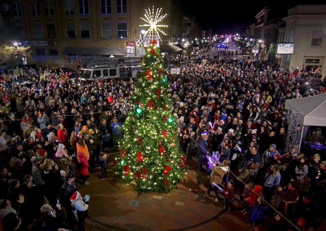 A crowd gathers on Court Square in Bardstown for the lighting of the city’s Christmas tree during Light Up Bardstown. A lit Christmas tree appears in the center of a large crowd downtown.