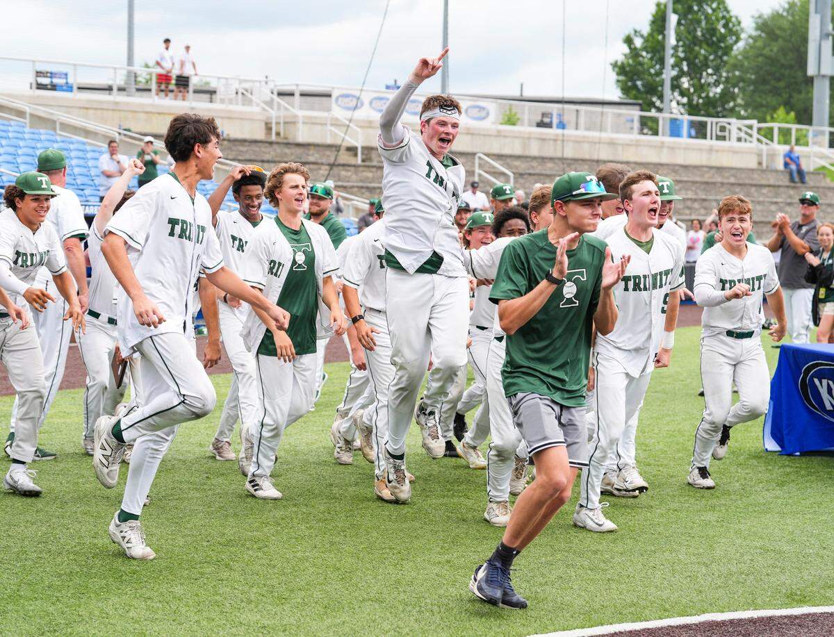 The Trinity baseball team celebrate as the receive the championship trophy after defeating PRP 2-1 in a late inning thriller at the 2025 KHSAA Boys Baseball state championship in Lexington, Kentucky Saturday, June 14, 2025.