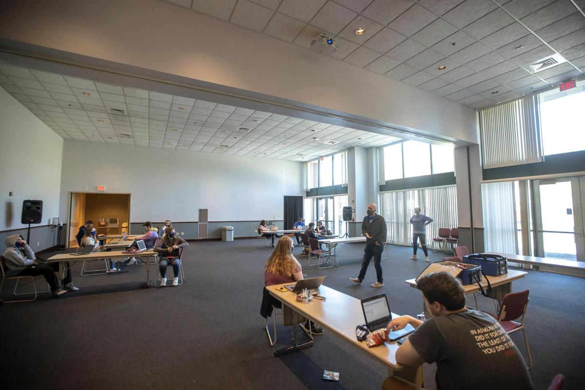 Shane Hecker, standing, center right, a teacher at Frankfort High School, speaks to students during an in-person class held at the Thomas D. Clark Center for Kentucky History in Frankfort, Ky., Friday, Nov. 6, 2020, before in-person classes were suspended throughout the state.