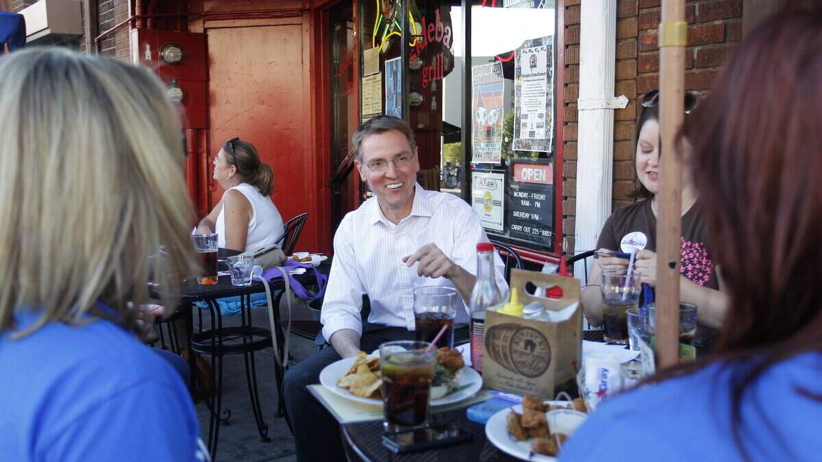 Jim Gray talked with members of Knitters for Gray outside the Sidebar Grill early this month. The vice mayor has taken a leave of absence from his job as CEO of Gray Construction to campaign for mayor.