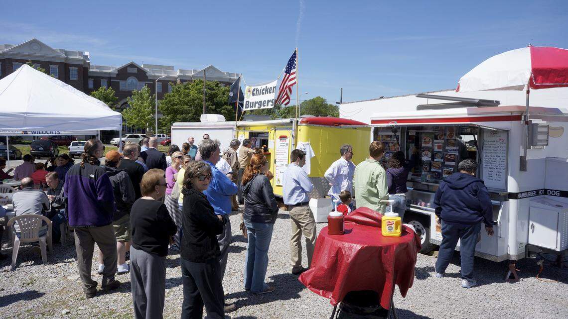 Customers lined up for food on Friday, April 27, 2012 at a lot between Vine St. and Main St. in Lexington, Ky.  This was the Bluegrass Food Blast, an event to share with Lexington the culinary offerings of mobile vendors. The goal was "to demonstrate to Lexingtonians the unique vibrancy that is food truck cuisine."  (news release).  Photo by David Perry | Staff