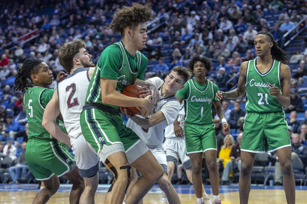 Great Crossing’s Malachi Moreno, foreground, and Magoffin County’s Walker Russell fight for the ball during a game in the 2024 Boys’ Sweet 16 state basketball tournament at Rupp Arena.
