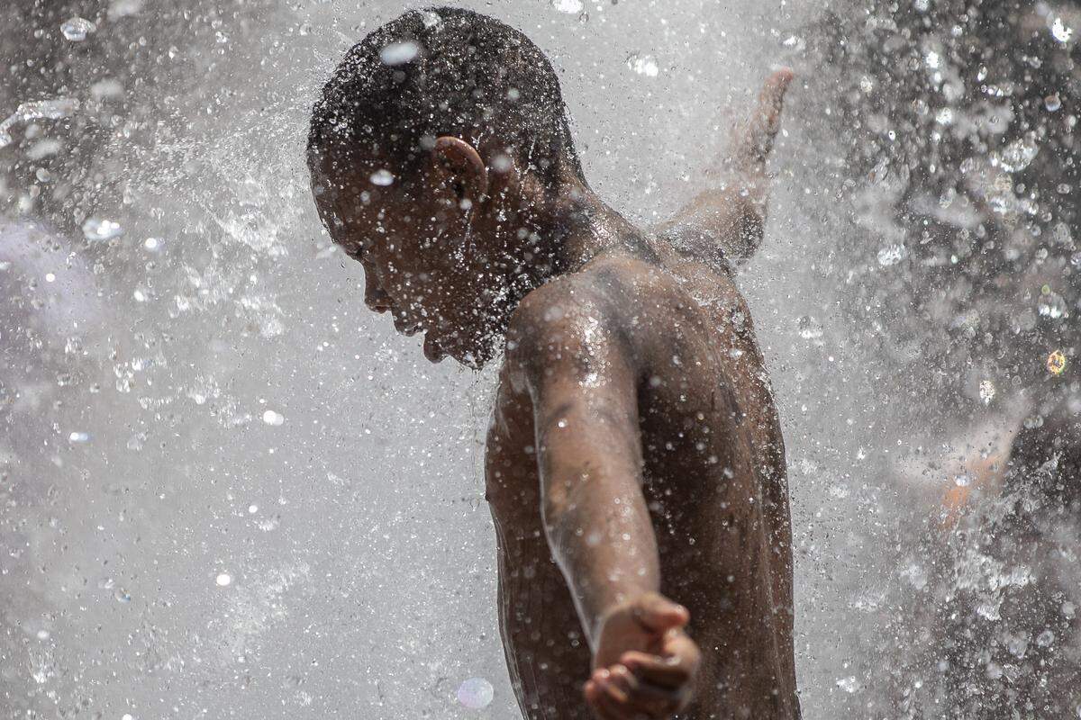 Jayden Guerrier, 8, of Lexington, plays in the courthouse fountain near East Short Street and North Limestone in downtown Lexington Thursday, June 27, 2019.