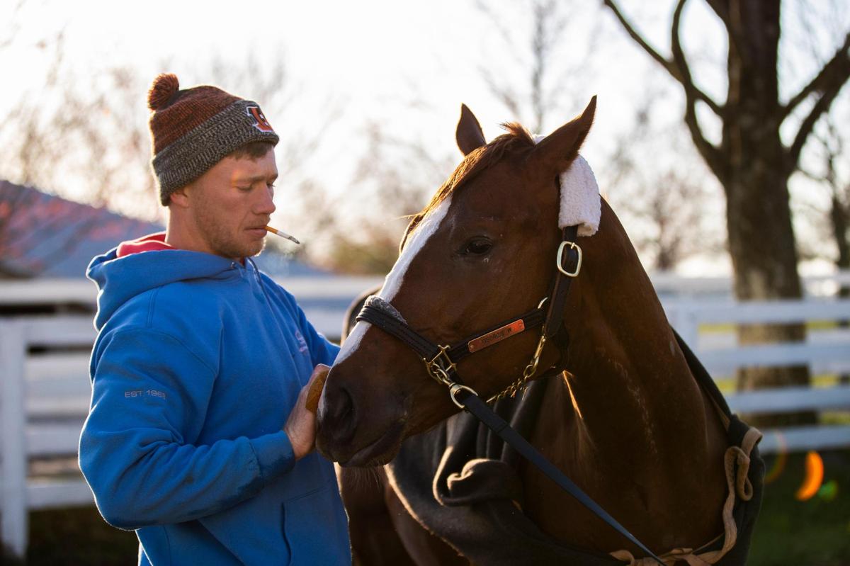Trainer Will Walden, 31, gives Ready Made Racing horse George W a quick bath after a morning workout at Keeneland in Lexington, Ky., Saturday, April 2, 2022. Walden has been sober for 16 months, the longest he has been sober since high school.