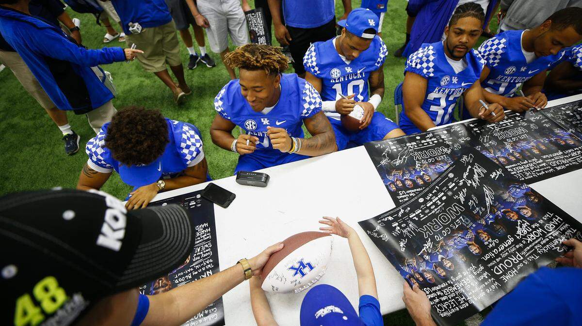 Benny Snell, second from left, and other UK running backs from last season signed autographs during the 2017 UK football Fan Day at Nutter Field House. This season’s Fan Day has been scheduled for Aug. 4. Snell will be among UK’s returning stars.