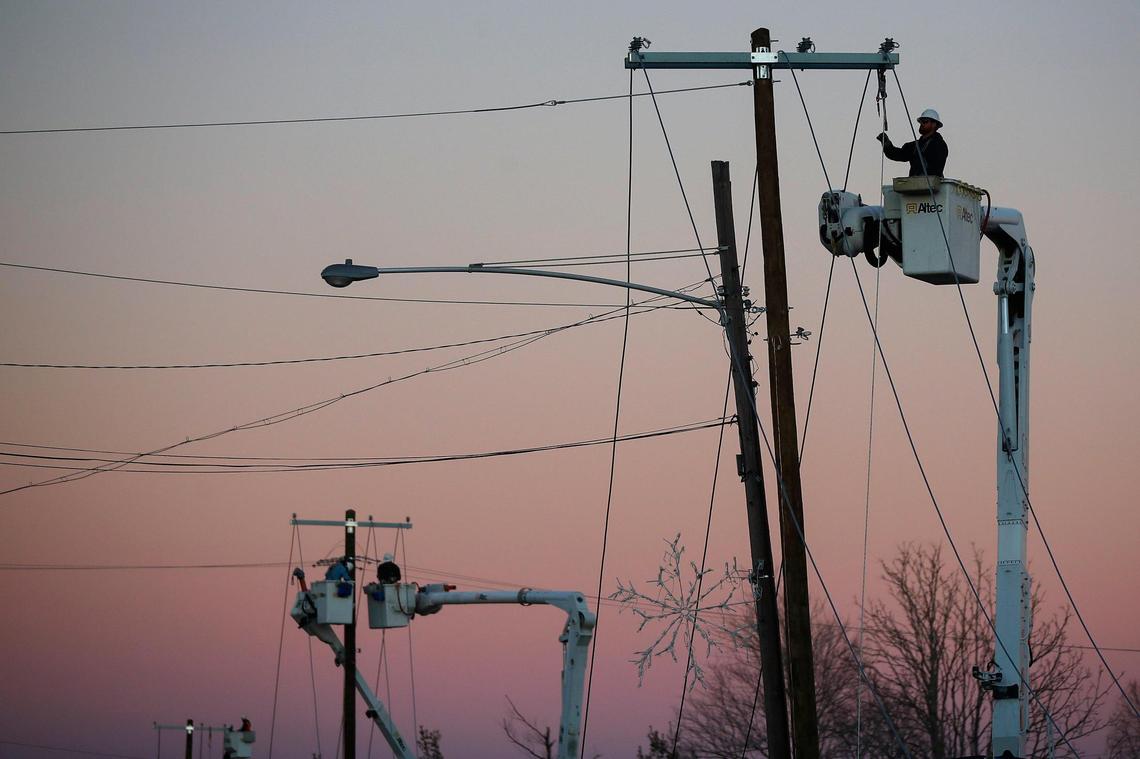 Isaiah Danis, of Mt. Sterling, Ky., a lineman with Kentucky Utilities works to restore power along East Arcadia Avenue in Dawson Springs, Ky., Monday, Dec. 13, 2021.