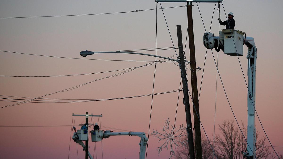Isaiah Danis, of Mt. Sterling, Ky., a lineman with Kentucky Utilities works to restore power along East Arcadia Avenue in Dawson Springs, Ky., Monday, Dec. 13, 2021.