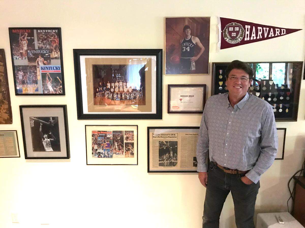 Former UK basketball player Chuck Verderber stood next to the “Wall of Fame” in his Vermont home. Over his right shoulder is an unopened letter he received from the Chicago Bulls after they drafted him in the seventh round in 1982.