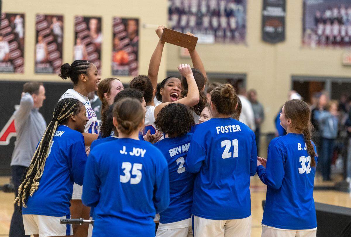 Belle Combs (holding trophy) celebrates with her teammates after Lafayette’s victory in the 43rd District Tournament championship game at Paul Laurence Dunbar on Friday night. Combs was named tournament MVP after putting up 17 points, nine rebounds and five blocks in the title game.