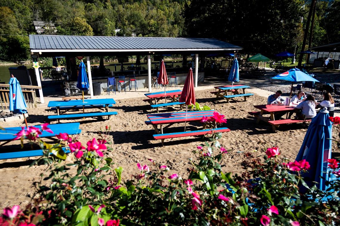 Customers enjoy food and drinks at the outdoor seating of Proud Mary BBQ.
