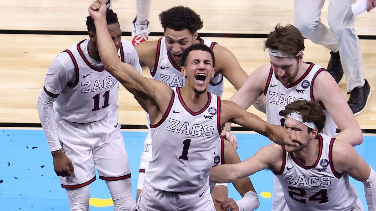 Gonzaga’s Jalen Suggs (1) celebrates with teammates after making a game-winning 3-point basket in overtime to defeat UCLA, 93-90, during the NCAA Tournament Final Four semifinals at Lucas Oil Stadium in Indianapolis on Saturday, April 3, 2021. (Andy Lyons/Getty Images/TNS)
