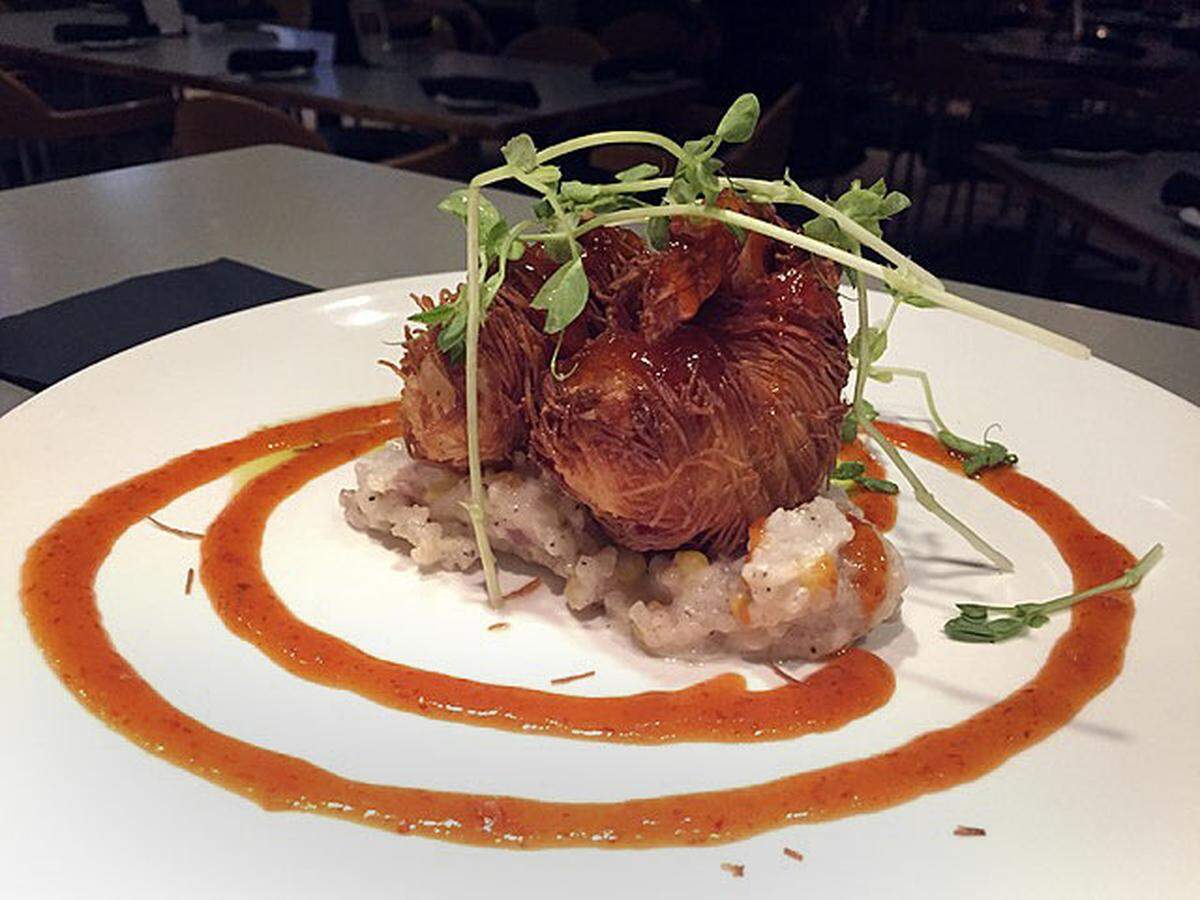 Azur’s signature woven shrimp are served over coconut sweet corn risotto with a honey, garlic and red chili glaze.