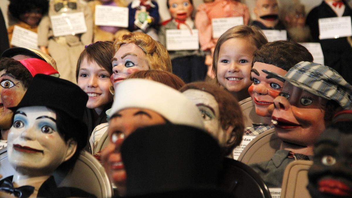 Sisters Emma Rose, 10, left, and Greta Craner, 4, posed for their mother among a collection of dummies as they toured Vent Haven Museum in Fort Mitchell last week. The museum holds hundreds of ventriloquist dummies, puppets and memorabilia. 