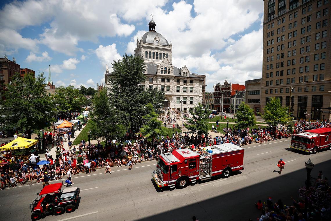 Lexington firefighters travel in front of the old Fayette County Courthouse during the city of Lexington’s Fourth of July parade along Main Street in downtown Lexington Ky., Thursday, July 4, 2019.